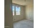New construction bedroom featuring drywall walls, concrete flooring, and double hung windows at 2300 E Spur Dr, San Tan Valley, AZ 85140