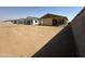 New construction homes lining a street, showcasing a growing community with spacious yards and modern designs at 2300 E Spur Dr, San Tan Valley, AZ 85140
