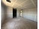 Spacious bedroom with unfinished drywall, featuring multiple doorways and window, ready for customization and personalization at 2325 E Homesteader Rd, San Tan Valley, AZ 85140