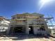 Two-story home under construction, showcasing its modern design and sturdy framework against a clear blue sky at 2325 E Homesteader Rd, San Tan Valley, AZ 85140