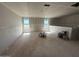 Upstairs living room with unfinished floors and walls, featuring a half wall, and ample space for flexible design at 2325 E Homesteader Rd, San Tan Valley, AZ 85140