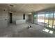Bright, unfinished living room with sliding glass doors, showcasing potential for indoor-outdoor living and natural light at 2325 E Homesteader Rd, San Tan Valley, AZ 85140