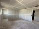 Unfinished living room showcasing drywall installation, doorway openings, and bright natural light at 2325 E Homesteader Rd, San Tan Valley, AZ 85140