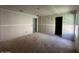 Unfinished living room featuring bare floors, drywall, and doorway openings at 2325 E Homesteader Rd, San Tan Valley, AZ 85140
