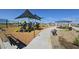 Community playground featuring colorful play structures, covered picnic areas, and benches in a Gathering-friendly setting at 2325 E Homesteader Rd, San Tan Valley, AZ 85140