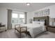 This primary bedroom features natural light, a tufted headboard, and neutral decor at 24260 W Pecan Rd, Buckeye, AZ 85326