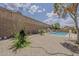 A spacious backyard with a refreshing pool, surrounded by a low-maintenance landscape and a tall brick wall at 2579 E Camellia Dr, Gilbert, AZ 85296