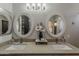Bathroom featuring double sinks with elegant lighting and decor, complemented by round decorative mirrors at 2579 E Camellia Dr, Gilbert, AZ 85296