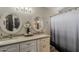 Bright bathroom features double sinks, modern fixtures, and a shower with a decorative light gray shower curtain at 2579 E Camellia Dr, Gilbert, AZ 85296