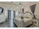 Bedroom featuring wood floors, bay windows, and a stunning canopy bed at 2579 E Camellia Dr, Gilbert, AZ 85296