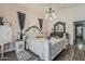Cozy bedroom featuring a decorated four-post bed, a small cabinet, and wood floors at 2579 E Camellia Dr, Gilbert, AZ 85296