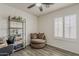 Bright bedroom featuring wood floors, a swivel chair, a metal bookshelf, and a window with shutters at 2579 E Camellia Dr, Gilbert, AZ 85296