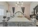 Bedroom featuring an ornate queen-sized bed, wood floors, and light pink walls at 2579 E Camellia Dr, Gilbert, AZ 85296