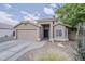 Charming single-story home featuring a two-car garage, desert landscaping, and a welcoming front entrance at 2579 E Camellia Dr, Gilbert, AZ 85296