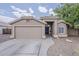 Charming single-story home featuring a two-car garage, desert landscaping, and a welcoming front entrance at 2579 E Camellia Dr, Gilbert, AZ 85296