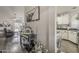 Hallway featuring modern decor, hardwood floors, and a glimpse into the living and kitchen spaces at 2579 E Camellia Dr, Gilbert, AZ 85296