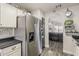 Open-concept kitchen showcasing a stainless steel refrigerator and a seamless flow to the living room at 2579 E Camellia Dr, Gilbert, AZ 85296