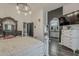 Spacious main bedroom featuring hardwood floors, stylish furnishings, and an open archway to the bathroom at 2579 E Camellia Dr, Gilbert, AZ 85296