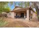 Backyard view featuring a covered patio and landscaping surrounding the house at 2610 E Leiber Ln, Phoenix, AZ 85024