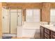 Bright bathroom with a glass enclosed shower and a separate soaking tub at 2610 E Leiber Ln, Phoenix, AZ 85024