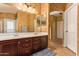 Traditional bathroom with a double vanity and a large mirror at 2610 E Leiber Ln, Phoenix, AZ 85024