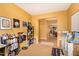 Bedroom with a bookshelf, a collection of decor, and view looking into the kitchen at 2610 E Leiber Ln, Phoenix, AZ 85024