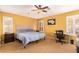 Bright bedroom featuring a ceiling fan and a dedicated workspace at 2610 E Leiber Ln, Phoenix, AZ 85024