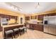 Modern kitchen featuring a center island with seating, tile flooring, and ample cabinet space at 2610 E Leiber Ln, Phoenix, AZ 85024