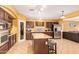 Well-equipped kitchen with dark wood cabinets, an island, and stainless steel appliances at 2610 E Leiber Ln, Phoenix, AZ 85024