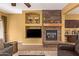 Inviting living room with a stone fireplace, built-in shelving, and a comfortable seating arrangement at 2610 E Leiber Ln, Phoenix, AZ 85024