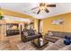Comfortable living room open to the kitchen, featuring a combination of leather and fabric sofas at 2610 E Leiber Ln, Phoenix, AZ 85024