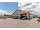 Spacious backyard features low-maintenance desert landscaping and covered patio at 3264 E Luna Dr, San Tan Valley, AZ 85143