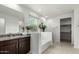 Bathroom featuring a vanity, tub, and a decorative privacy glass window at 3264 E Luna Dr, San Tan Valley, AZ 85143