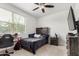 Bedroom with a desk, TV, ceiling fan and a wooden headboard at 3264 E Luna Dr, San Tan Valley, AZ 85143