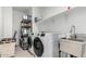 Laundry room with modern washer and dryer plus stainless sink at 3264 E Luna Dr, San Tan Valley, AZ 85143