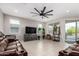 Spacious living room with tile flooring, a large ceiling fan, and ample natural light at 3264 E Luna Dr, San Tan Valley, AZ 85143