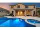 Stunning backyard with a shimmering pool, spa, and covered patio, ideal for entertaining and leisure at 35206 N 27Th Ave, Phoenix, AZ 85086
