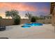 Serene backyard featuring a pool, spa, and meticulously landscaped grounds, creating a private oasis at 35206 N 27Th Ave, Phoenix, AZ 85086