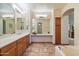 Bright primary bathroom featuring dual vanities, tile flooring, and a separate tub and shower at 35206 N 27Th Ave, Phoenix, AZ 85086