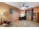 Bedroom with a desk, chair, ceiling fan, and large window for natural light at 35206 N 27Th Ave, Phoenix, AZ 85086