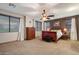 Well-lit bedroom with a ceiling fan, dresser, king bed and windows with wooden blinds at 35206 N 27Th Ave, Phoenix, AZ 85086