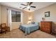 Bedroom with a bed, chest of drawers, ceiling fan, carpet and a window with curtains at 35206 N 27Th Ave, Phoenix, AZ 85086