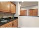 Butler's pantry offers granite counters, stylish backsplash, sink, and oak cabinets for extra storage at 35206 N 27Th Ave, Phoenix, AZ 85086