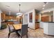 A modern dining area features a chandelier and a square table with seating for four at 35206 N 27Th Ave, Phoenix, AZ 85086