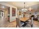 Open-concept dining area features a modern chandelier and a square table with seating for four at 35206 N 27Th Ave, Phoenix, AZ 85086
