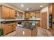 Modern kitchen with wooden cabinets, granite countertops, an island and modern appliances offering a chef's dream space at 35206 N 27Th Ave, Phoenix, AZ 85086