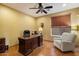 A cozy office with dark wood desk and a comfortable chair, perfect for working from home at 35206 N 27Th Ave, Phoenix, AZ 85086
