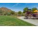 A colorful playground with a mountain in the background at 35206 N 27Th Ave, Phoenix, AZ 85086
