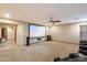 Large theater room features a large projection screen, ceiling fan, and carpeted flooring at 35206 N 27Th Ave, Phoenix, AZ 85086