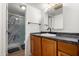 Bathroom with wood vanity and shower with marble-style walls at 3646 N 67Th Ave # 20, Phoenix, AZ 85033